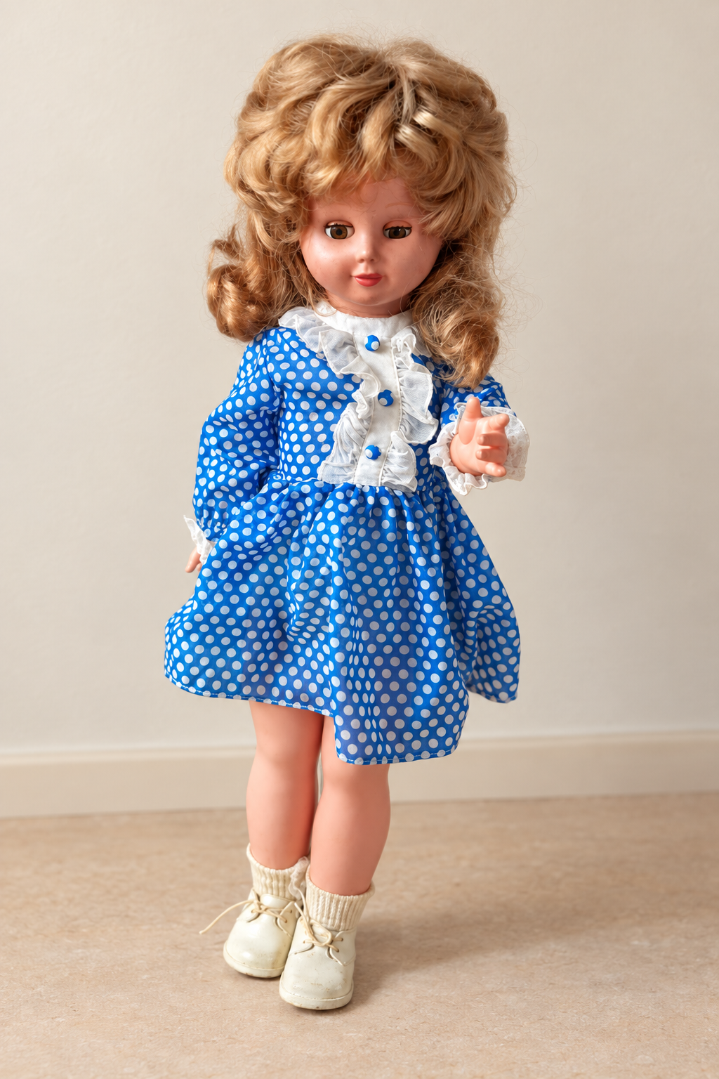 Poupée Unica de 60 cm — la trouvaille de Karin — Une seconde vue de la poupée Unica de Karin, en robe bleue à pois blancs, avec un bras levé — vue 2.