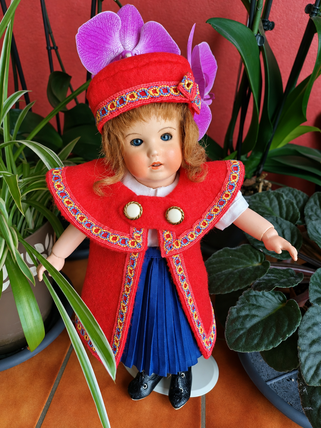 Bleuette 251 — la nouvelle tenue rouge et bleue cousue par Françoise — La Bleuette de Françoise vue de face, avec son chapeau rouge bordé de galon, sa jupe bleue plissée et ses bottines à lacets — vue 3.